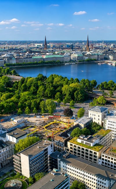 Aerial view of Hamburg from Rotherbaum, looking across the Alster lake to the city centre skyline with its church spires and town hall.