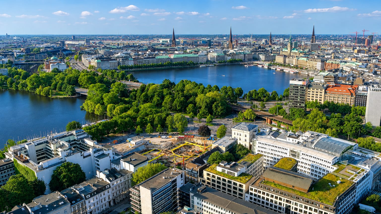 Aerial view of Hamburg from Rotherbaum, looking across the Alster lake to the city centre skyline with its church spires and town hall.