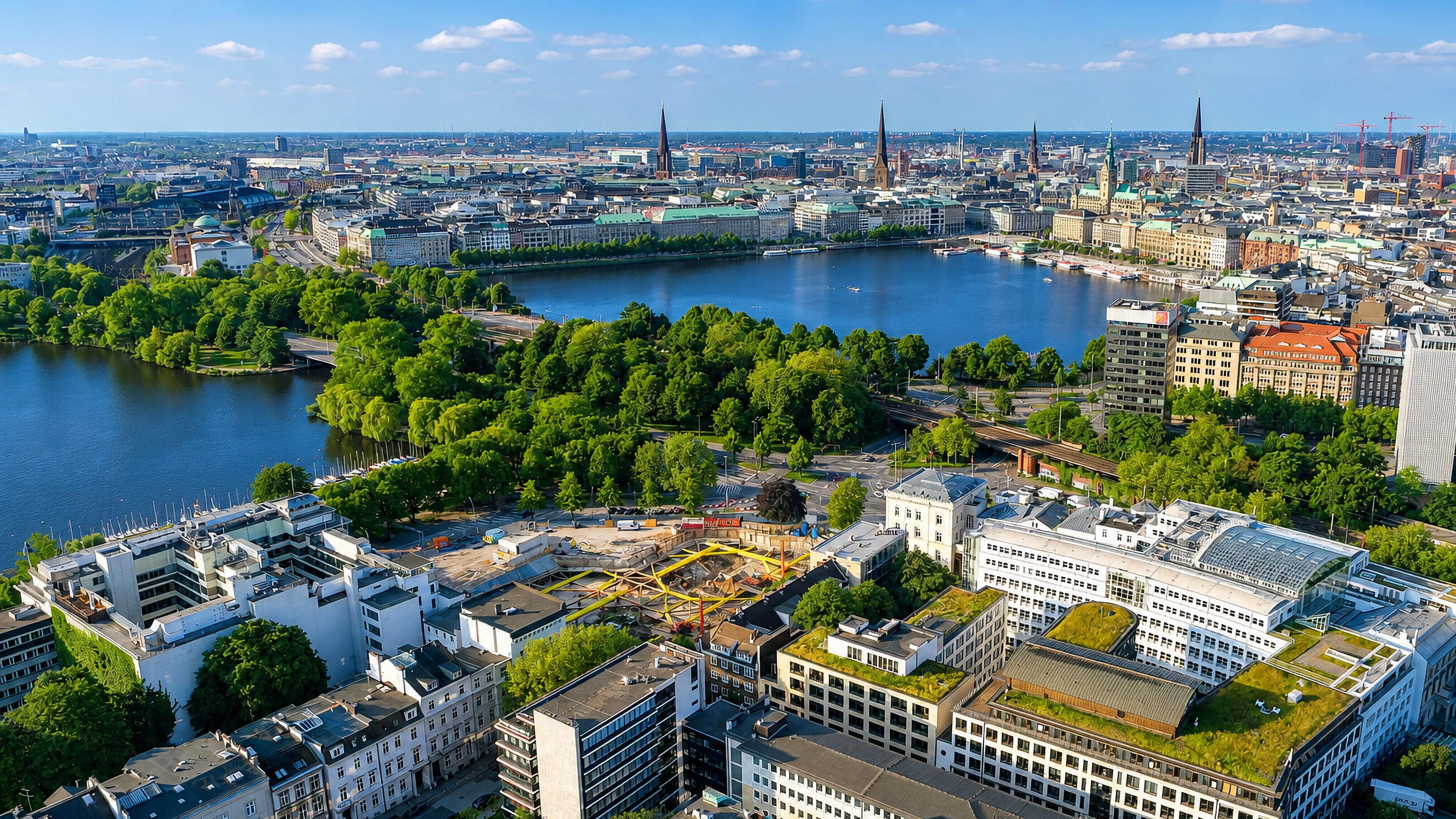 Aerial view of Hamburg from Rotherbaum, looking across the Alster lake to the city centre skyline with its church spires and town hall.