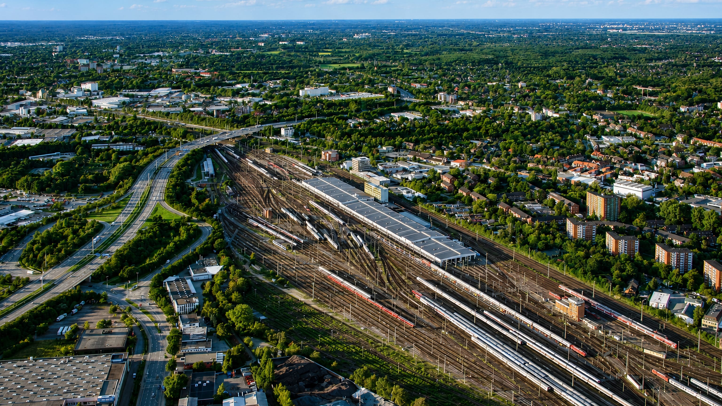 Aerial view of the railway yards and green suburban surroundings of Stellingen in Hamburg on a sunny day.