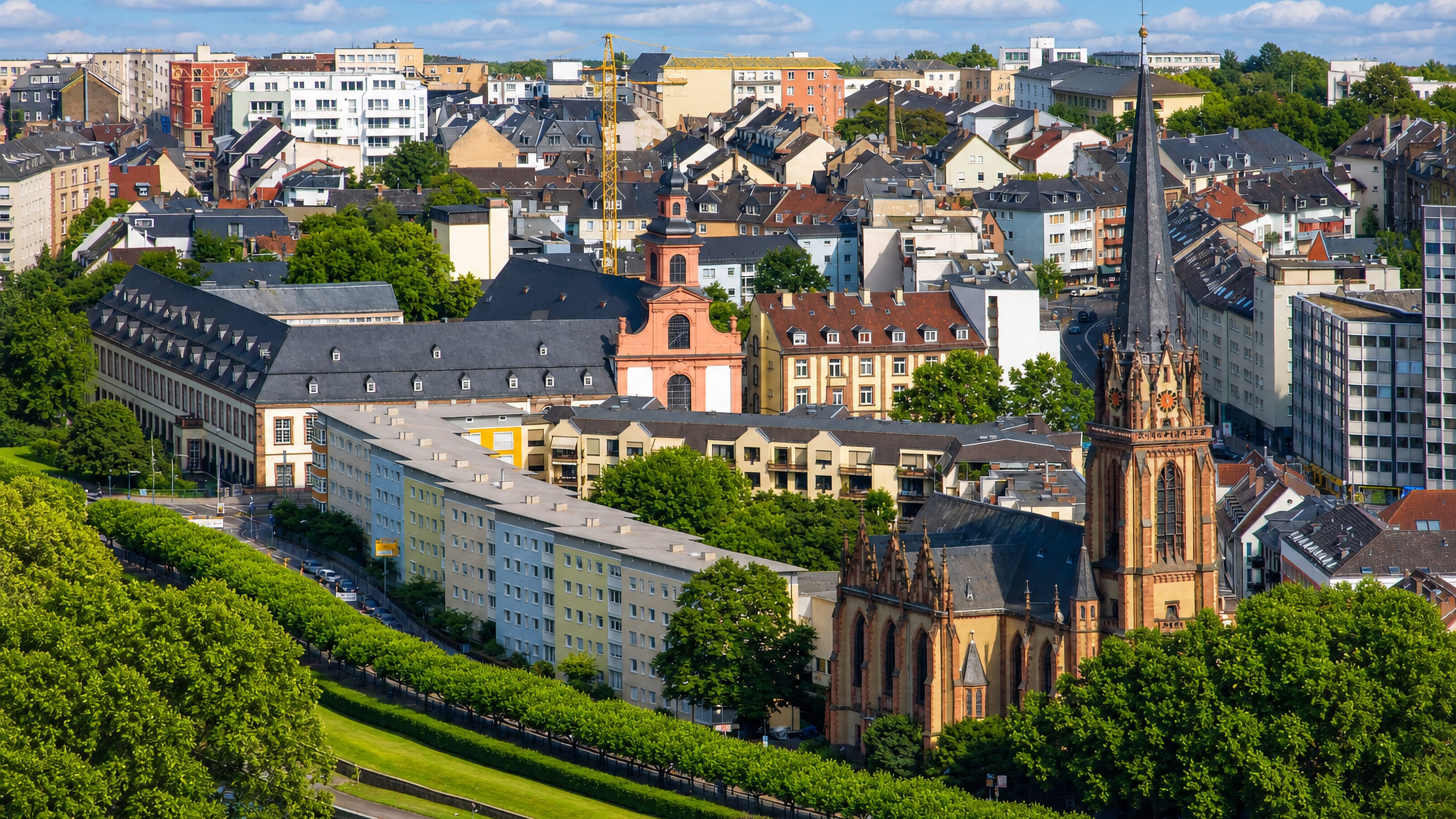 Frankfurt's Sachsenhausen-Nord district above the tree-lined Main riverbank, a Gothic church spire rising over the rooftops.