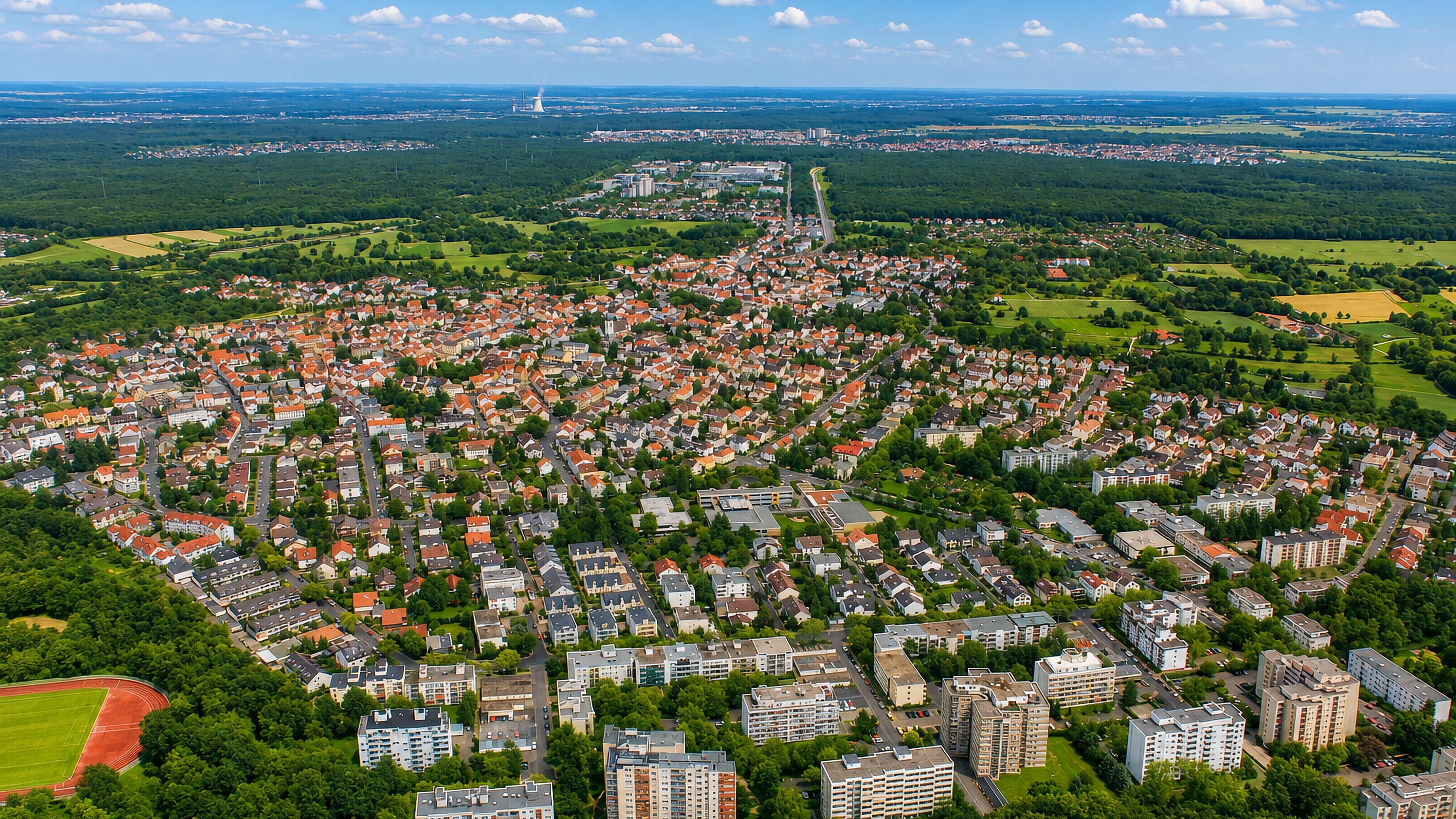 Aerial view of Bieber in Offenbach, its houses and apartment blocks ringed by forest and fields