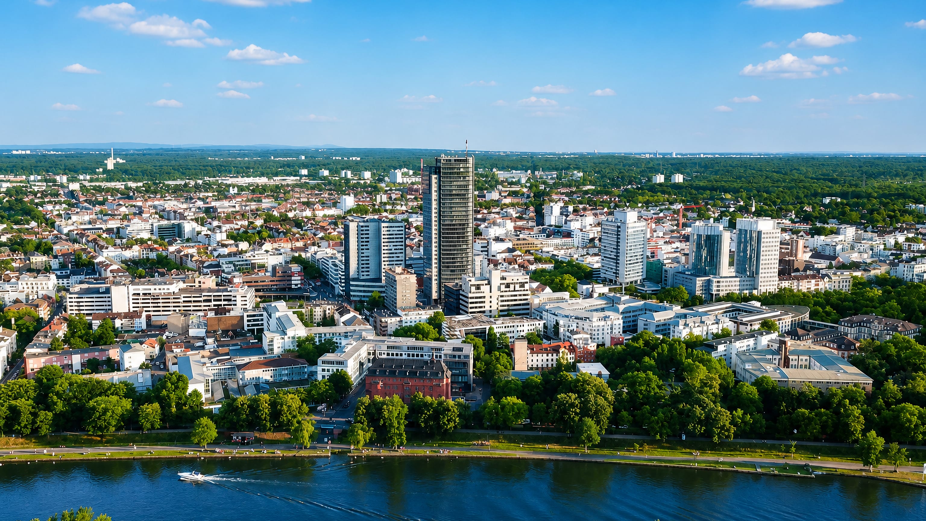 Offenbach am Main, Germany, seen across the River Main, a dark high-rise tower above the city centre.