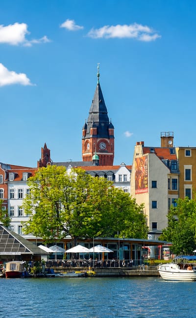 Köpenick old town waterfront on the Dahme river in Berlin, with the town hall tower, church spire and colourful facades.