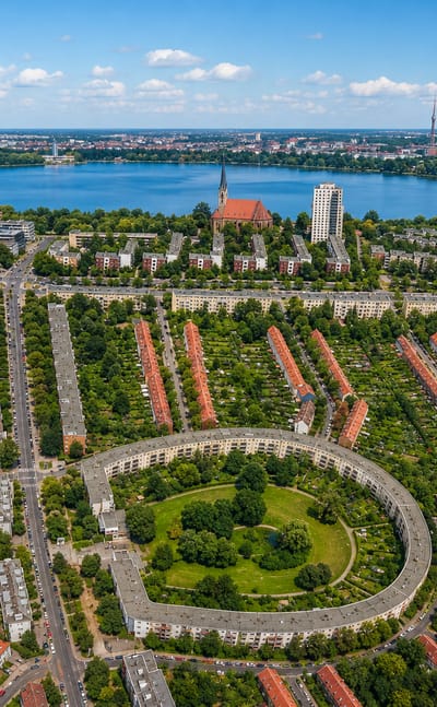 Aerial of Britz in Berlin showing Bruno Taut's horseshoe-shaped Hufeisensiedlung estate with the TV tower on the horizon