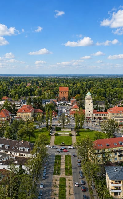 Aerial view of the Frohnau garden city in Berlin, its water tower and casino square framed by forest