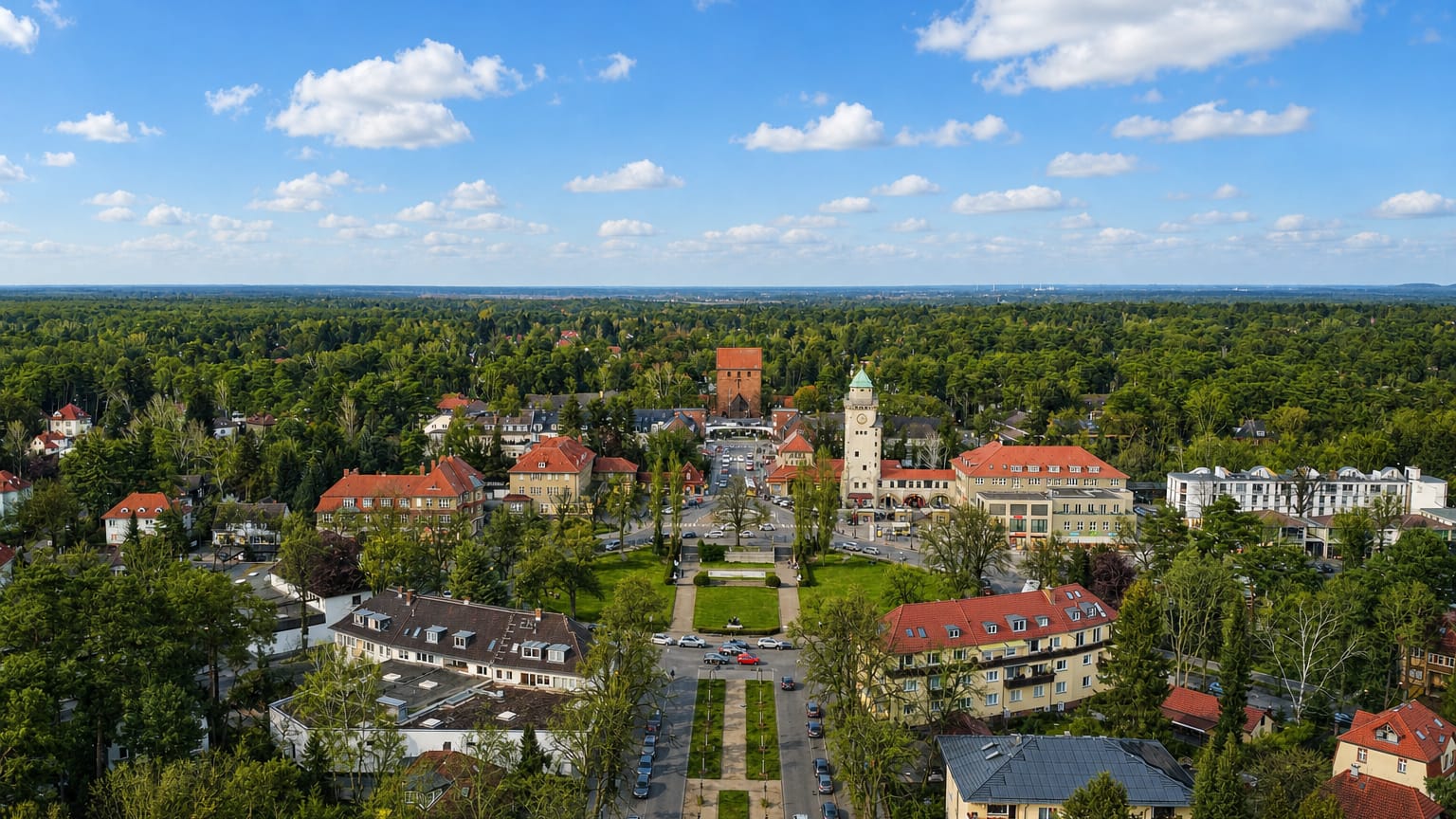 Aerial view of the Frohnau garden city in Berlin, its water tower and casino square framed by forest