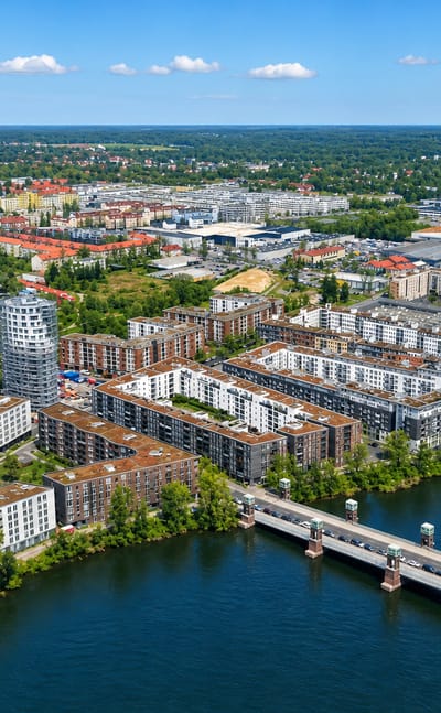 Aerial of the modern Havel-side Wasserstadt housing in Hakenfelde, Berlin, with a road bridge and round tower