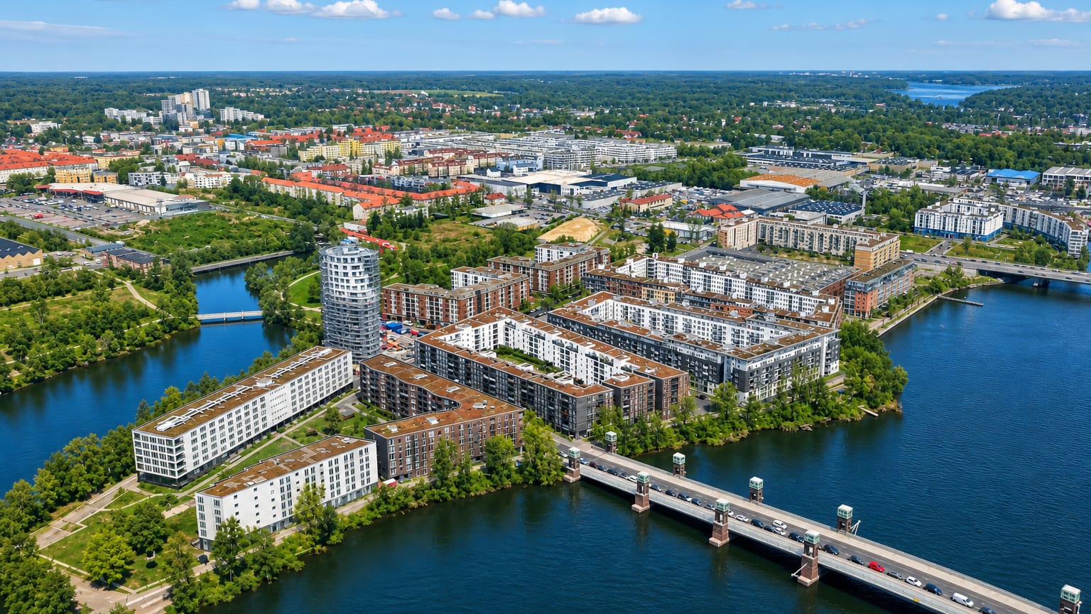 Aerial of the modern Havel-side Wasserstadt housing in Hakenfelde, Berlin, with a road bridge and round tower