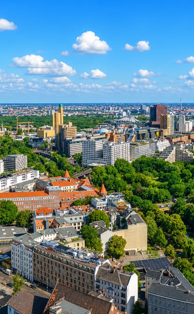 Aerial view of dense inner-city Berlin at Kreuzberg with an elevated U-Bahn viaduct, canal and mixed rooftops