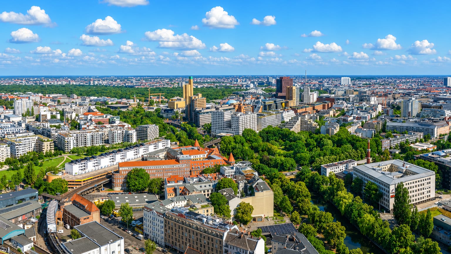 Aerial view of dense inner-city Berlin at Kreuzberg with an elevated U-Bahn viaduct, canal and mixed rooftops