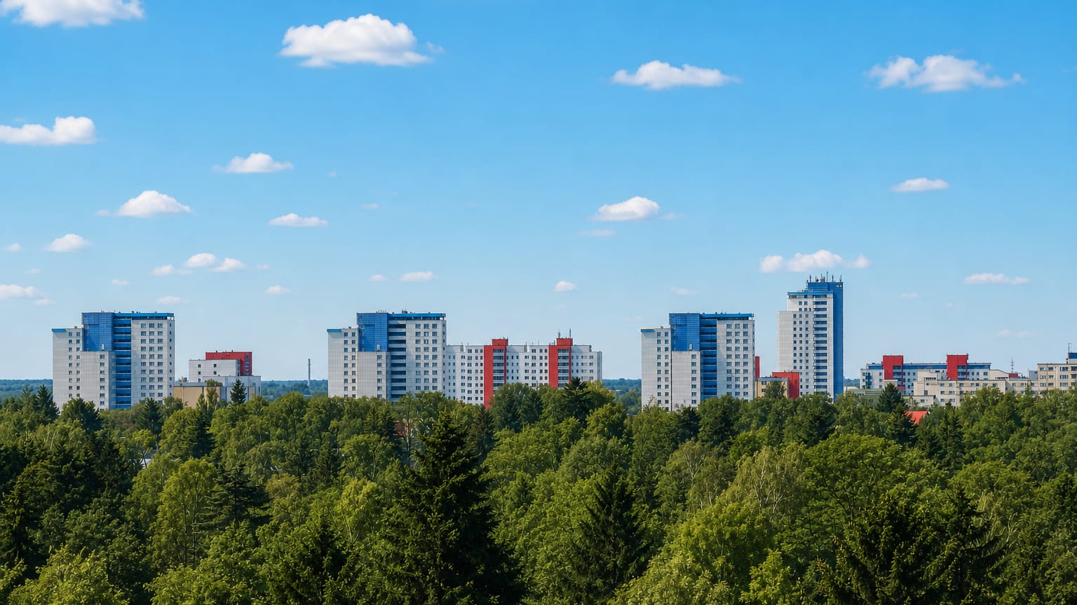 Cluster of high-rise apartment towers rising above a dense tree line in Lichterfelde, Berlin, under a clear sky