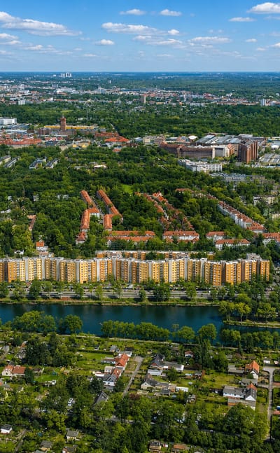 Aerial view of residential apartment blocks and allotment gardens along a canal in Siemensstadt, outer Berlin.
