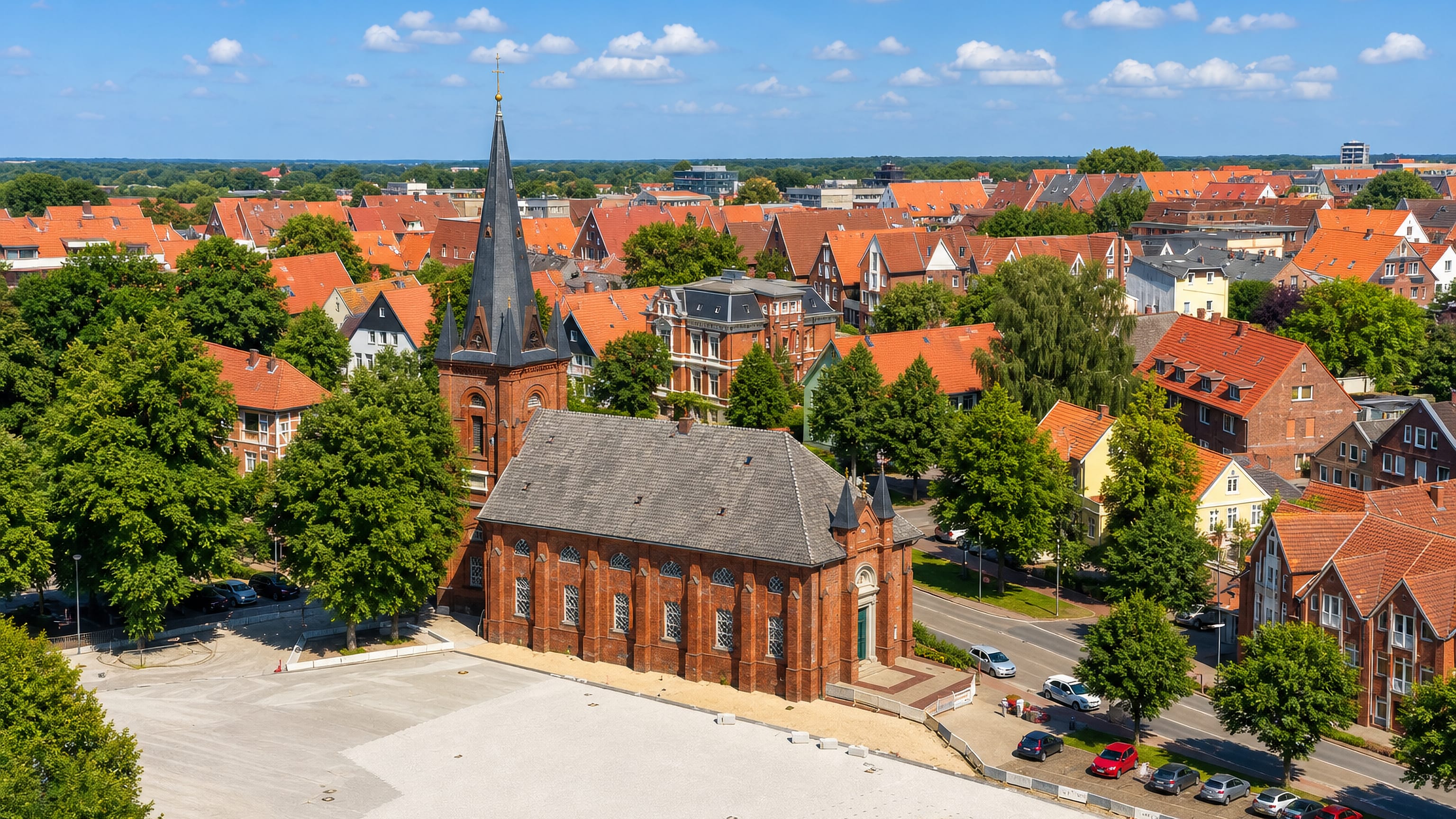 Red-tiled rooftops and a brick church spire above the old town quarter of Ritzebuettel in Cuxhaven.