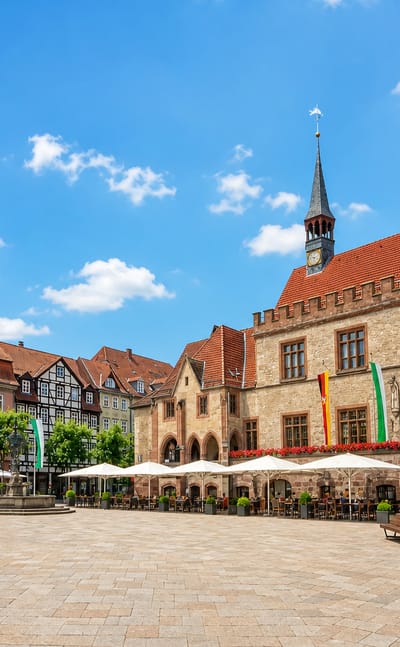 Gottingen's market square with the historic Altes Rathaus, half-timbered houses and cafe umbrellas
