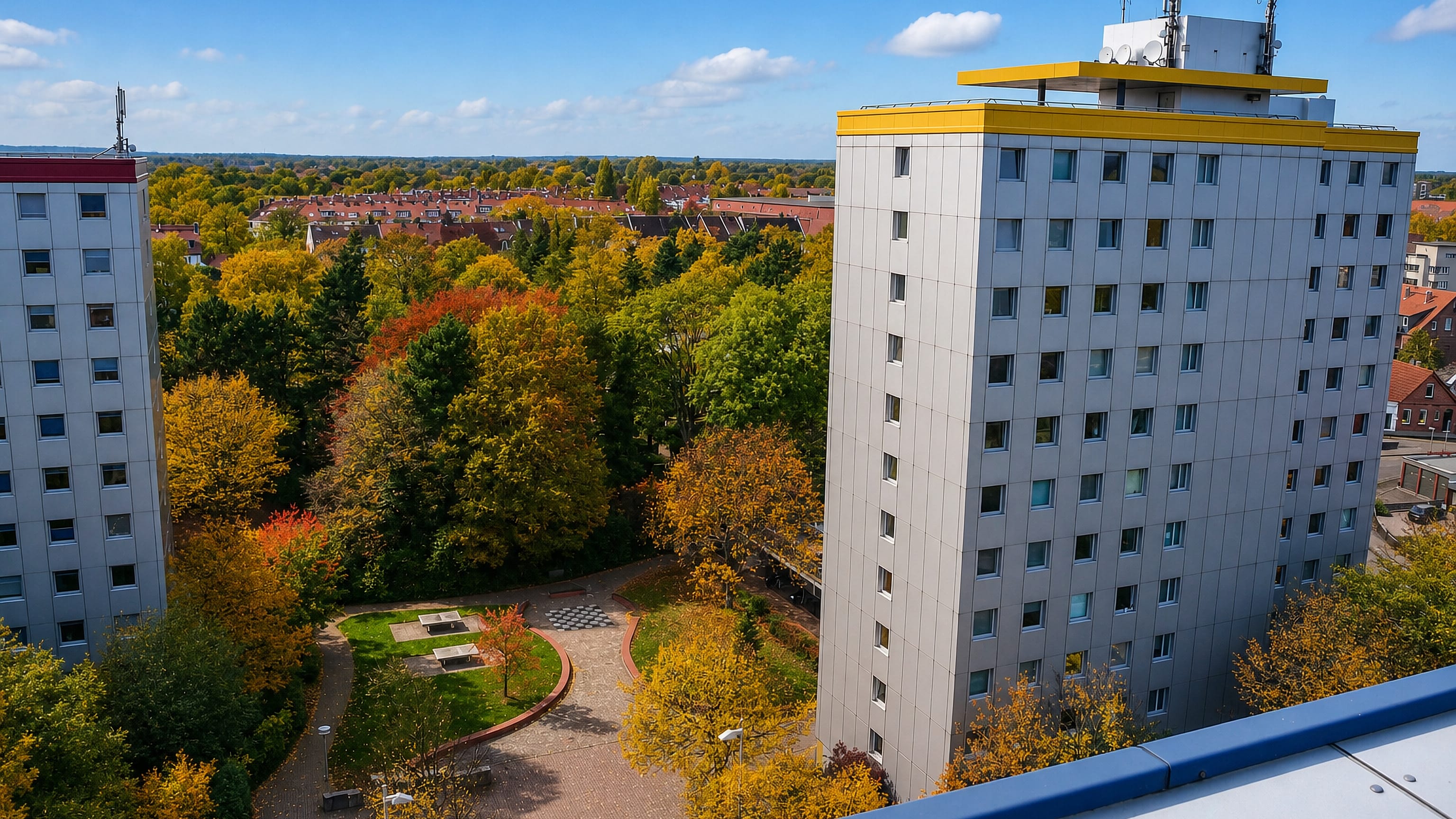 Postwar high-rise apartment towers among autumn trees in Herrenhausen, Hannover.