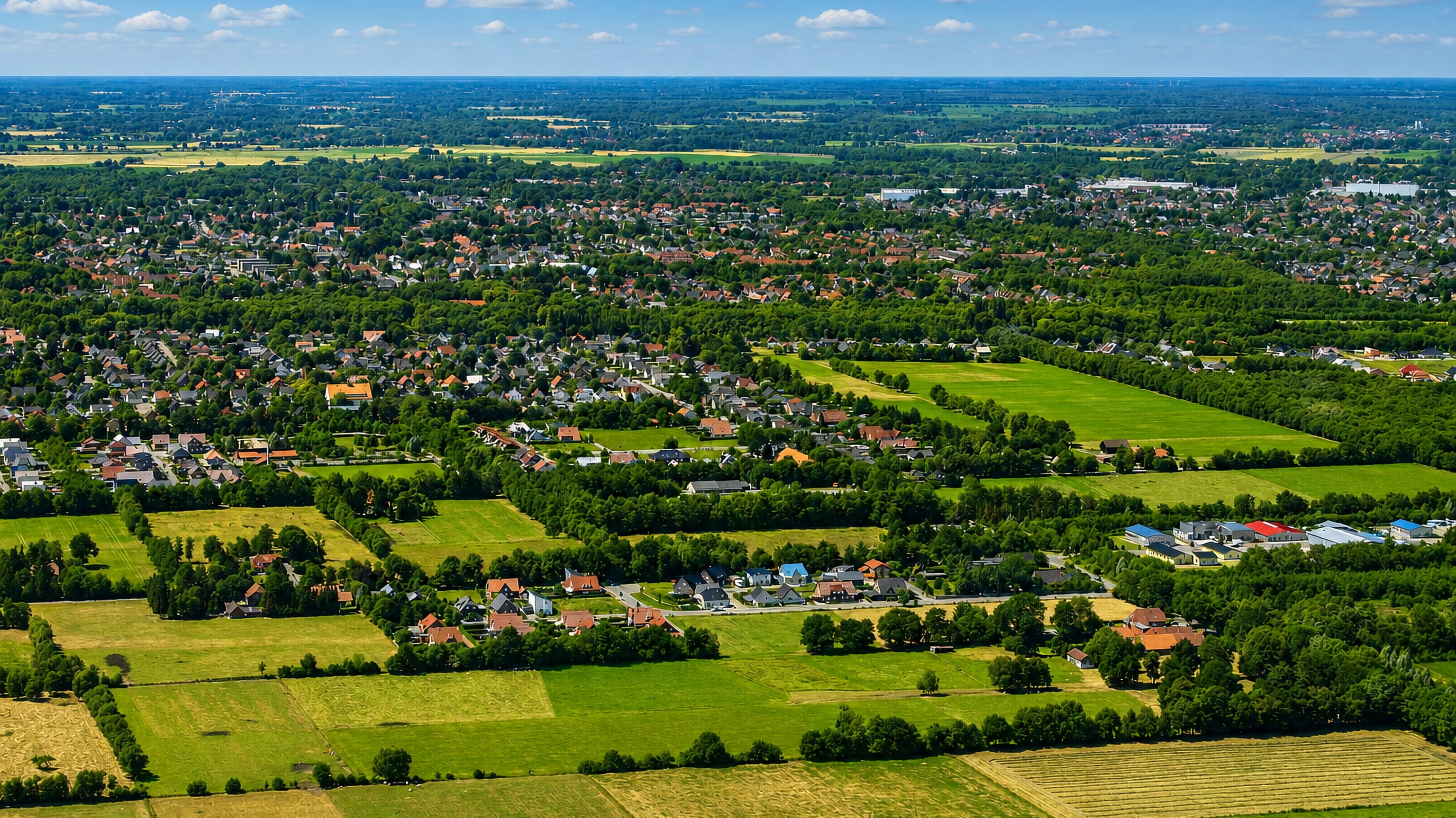 Aerial patchwork of fields, hedgerows and suburban houses at Krusenbusch on the edge of Oldenburg.