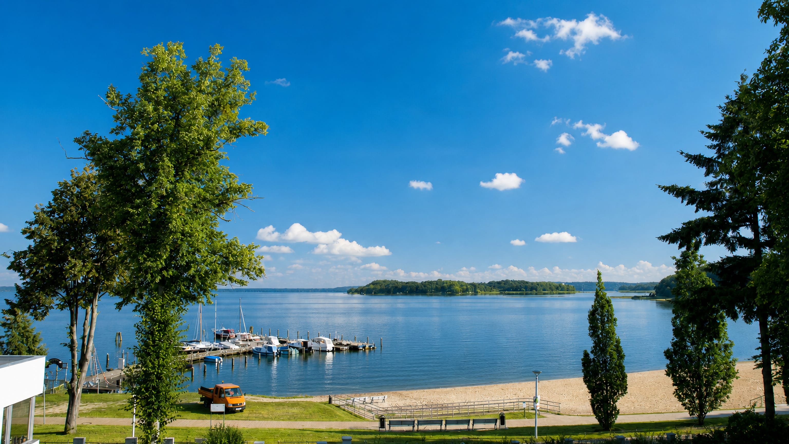 The Schweriner See beach and marina at Zippendorf, Schwerin, on a clear summer day.