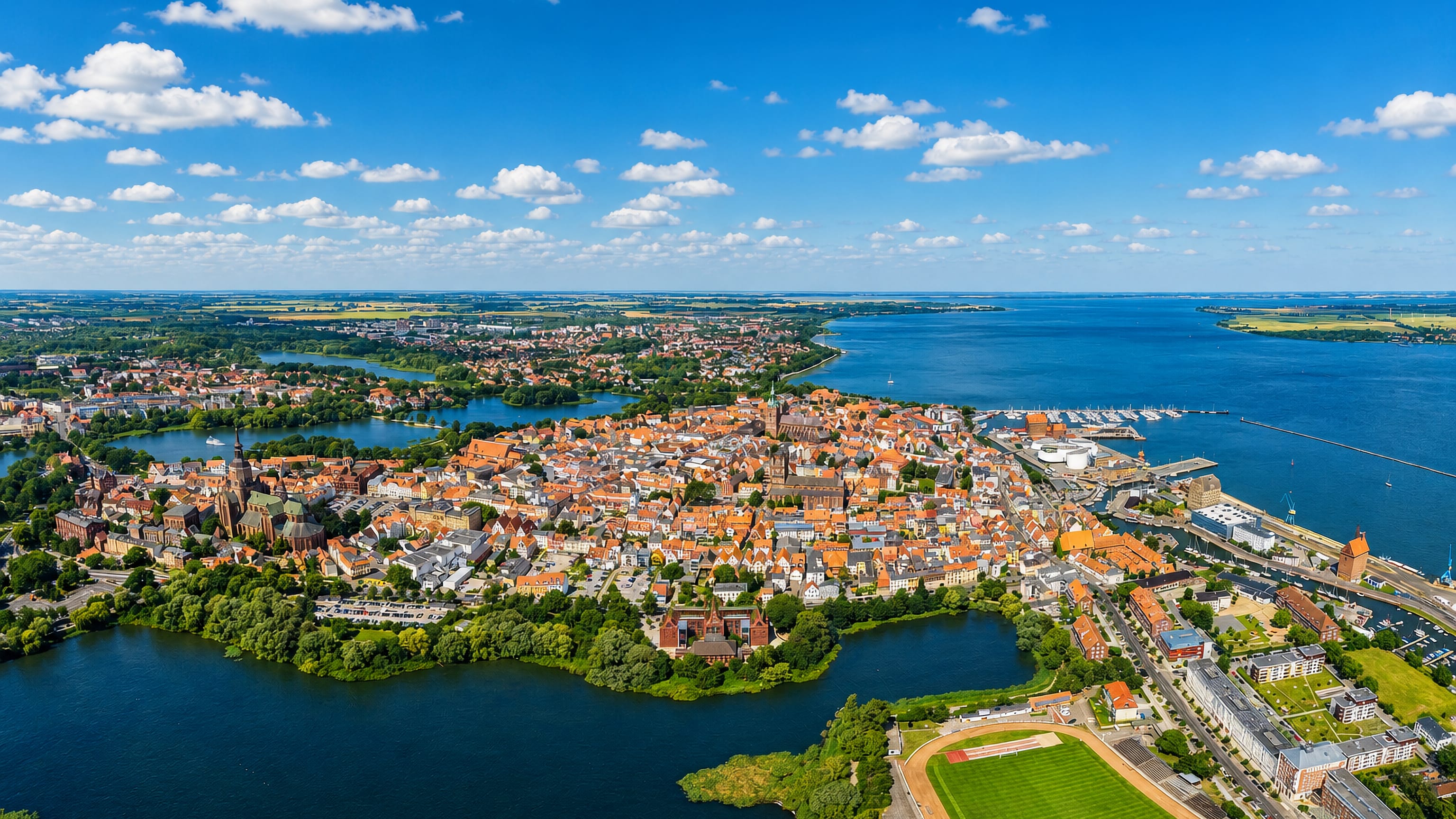 Aerial view of Stralsund's red-roofed old town on its peninsula between the Knieper ponds and the Strelasund