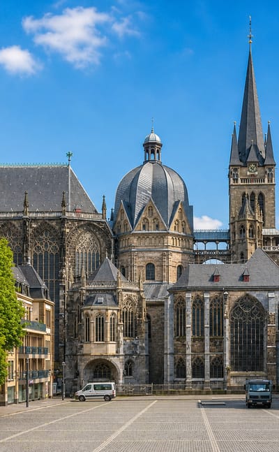 Aachen Cathedral with its octagonal dome and Gothic spire seen from the plaza in Aachen-Mitte, Germany.