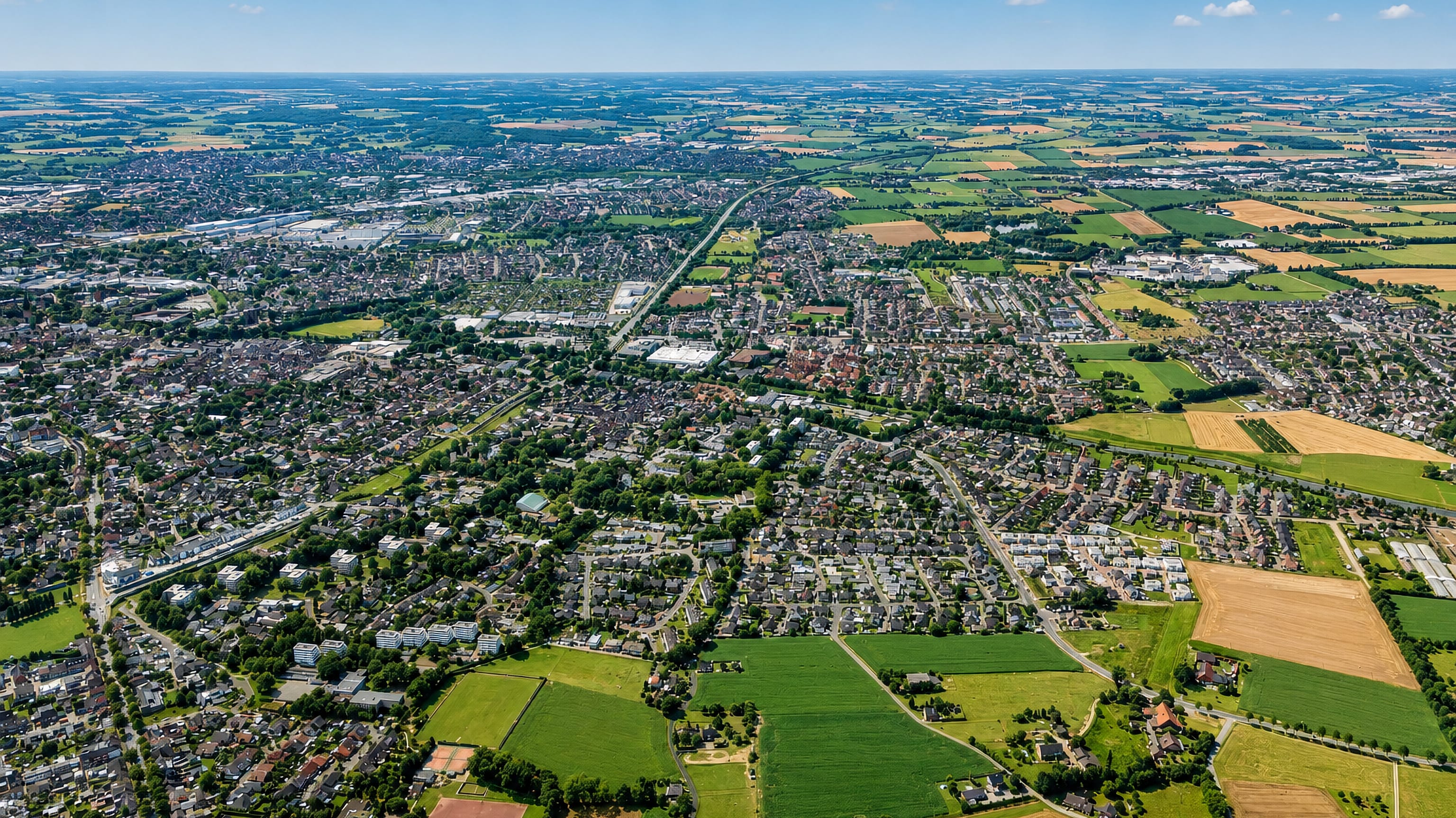 High aerial view of Bocholt, Germany, its housing spreading into the flat Munsterland fields and hedgerows