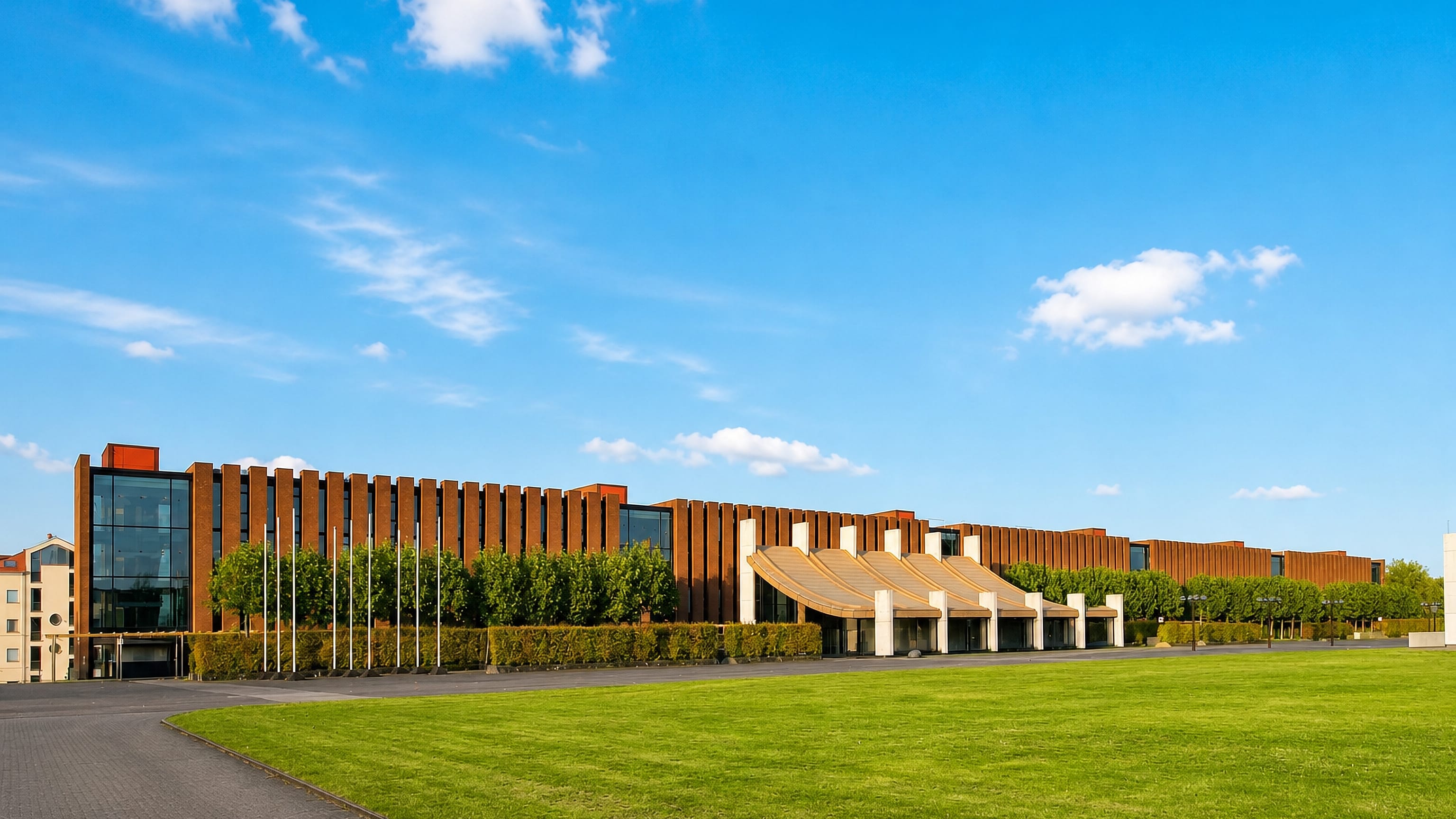 Long red-brick modernist civic complex behind a broad lawn in Castrop-Rauxel, North Rhine-Westphalia.