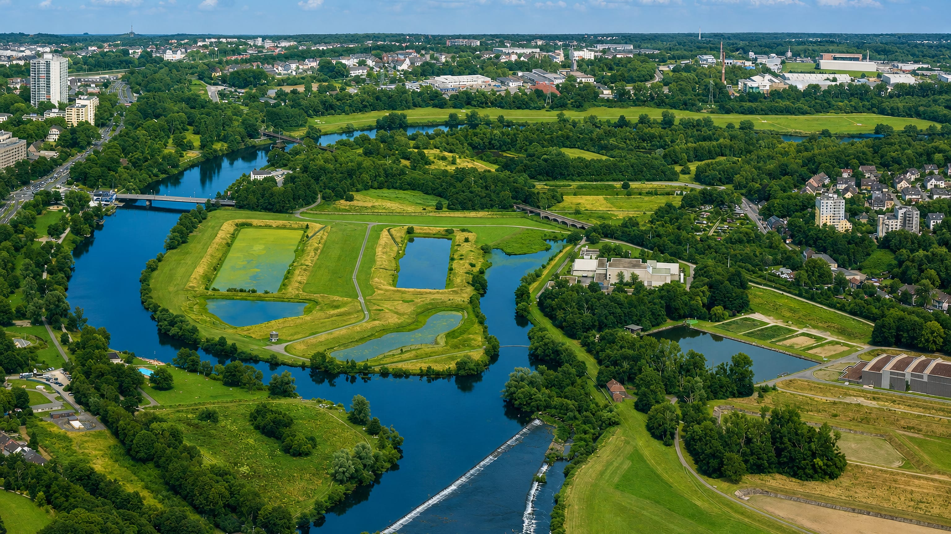 Aerial view of the River Ruhr curving past the meadows and housing of Überruhr in Essen.