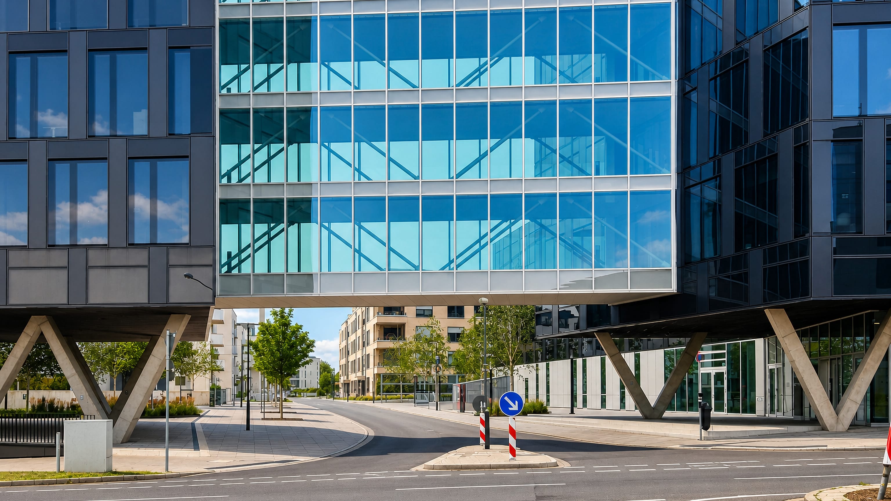 Modern glass office block raised on V-shaped supports in Essen's Westviertel business quarter.