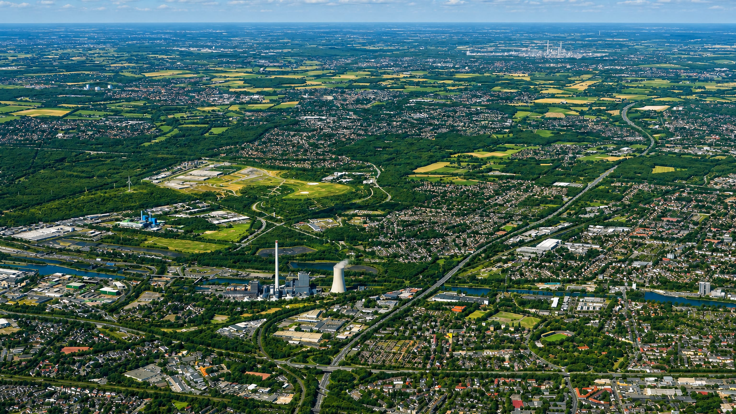 Aerial view over Herne in Germany's Ruhr area, showing the Rhine-Herne Canal, power plant and green former colliery land