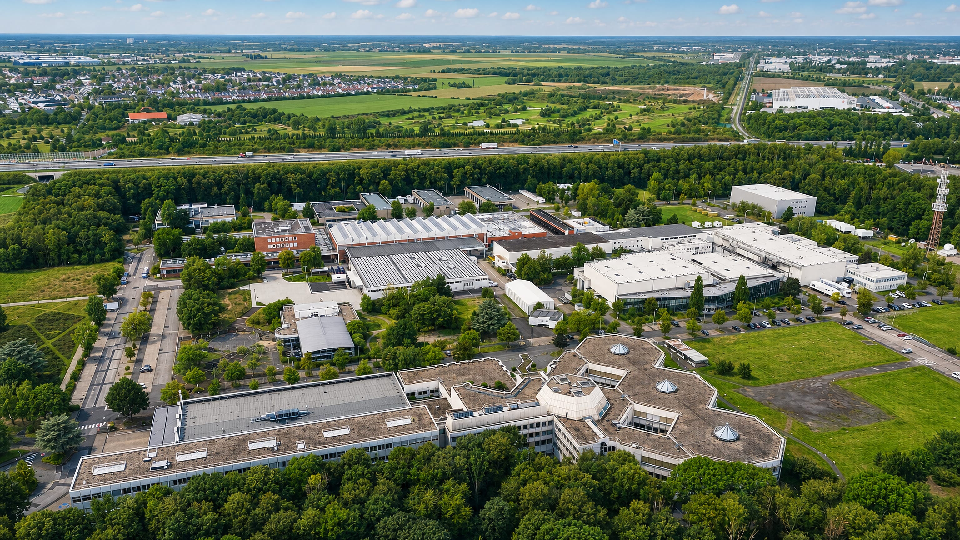 Aerial of Mengenich's office and industrial park beside the autobahn and fields northwest of Cologne