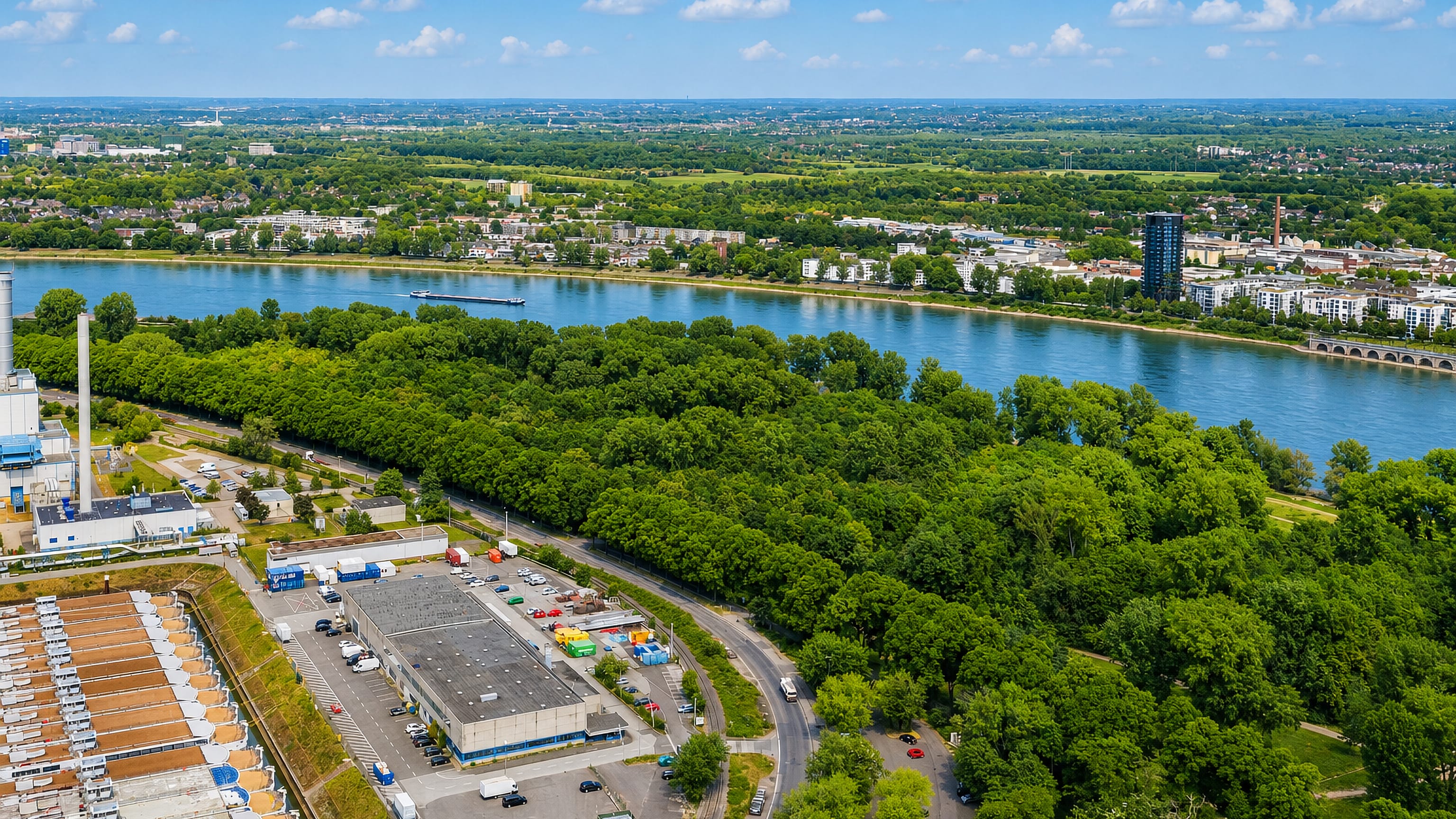 Aerial view of the Rhine, riverside woods and industrial works at Riehl in northern Cologne.