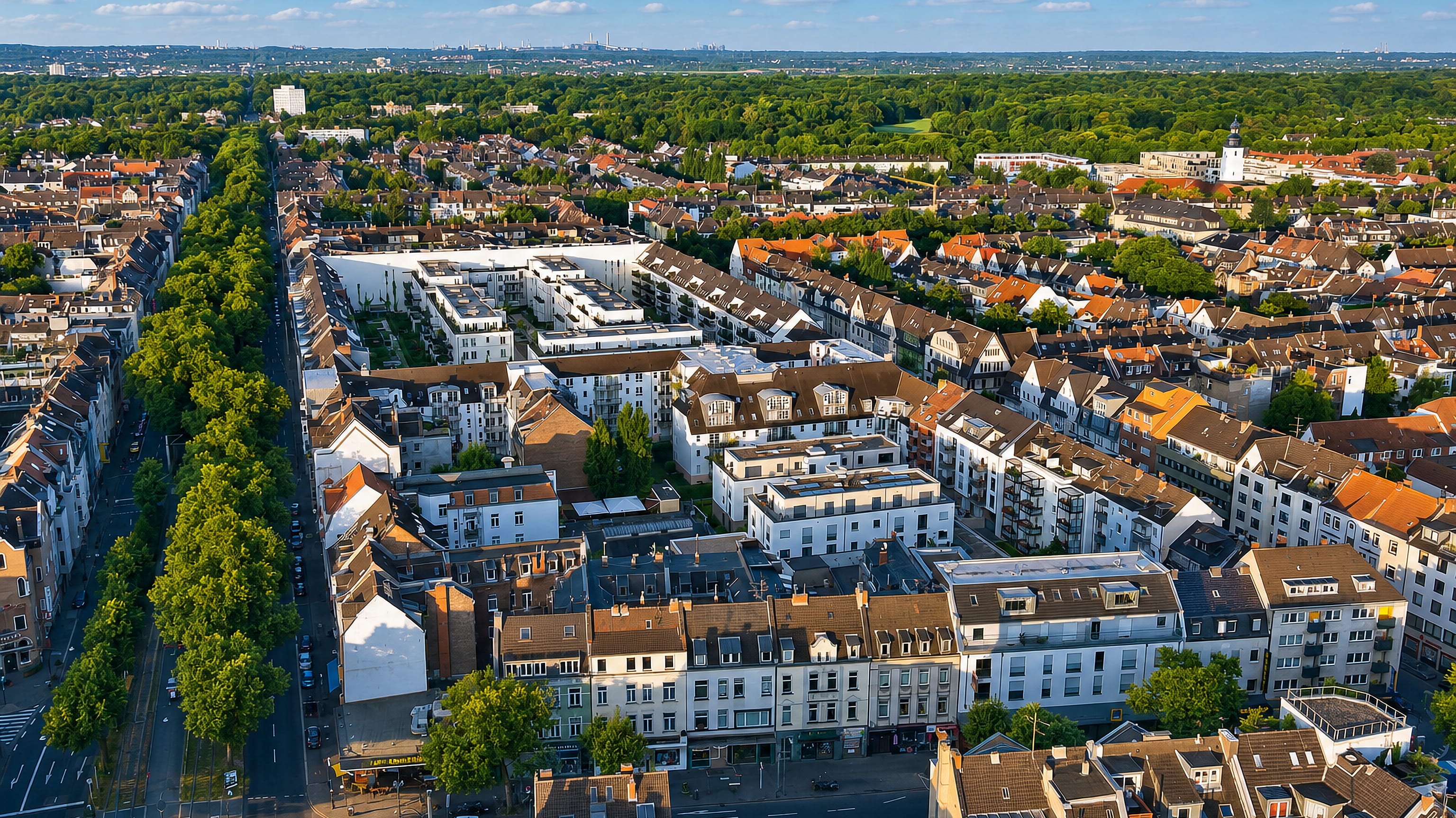 Aerial view of Sülz in Cologne, with Gründerzeit blocks along a tree-lined boulevard beside the Stadtwald.