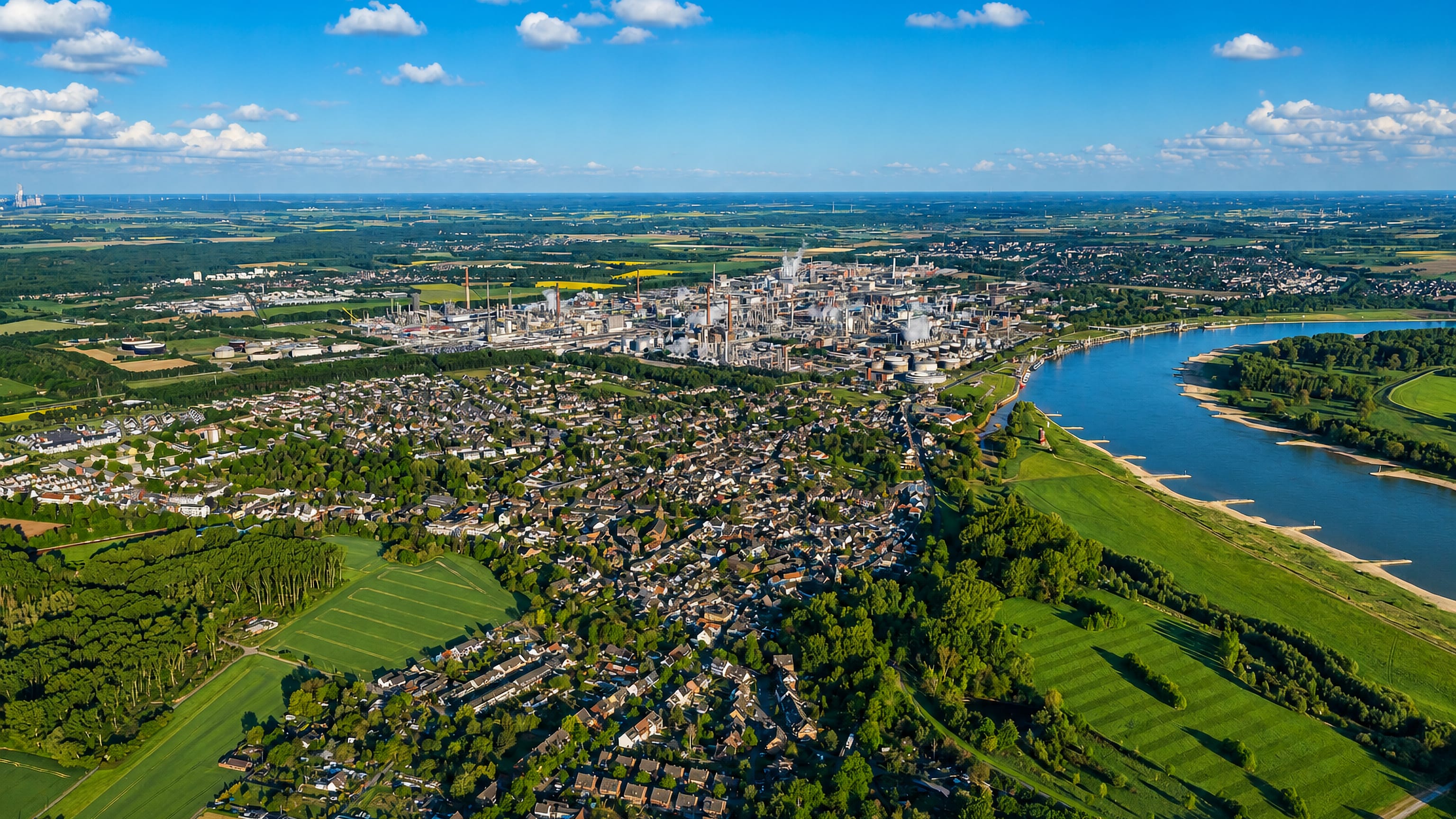 Aerial view of Worringen on the Rhine north of Cologne, with its chemical works and riverside meadows.