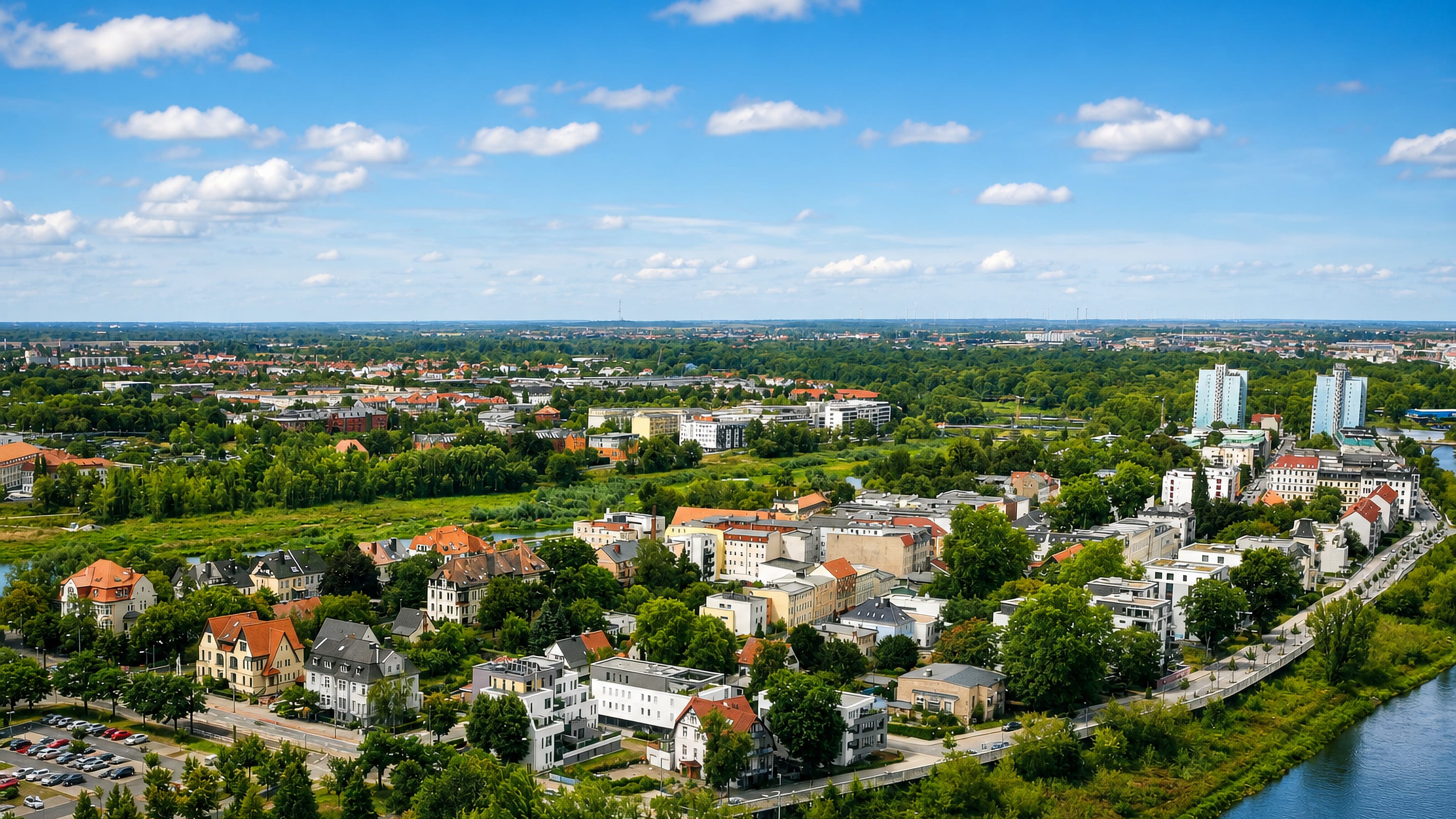 Aerial view over the villas and riverside blocks of Werder island in Magdeburg beside the Elbe.