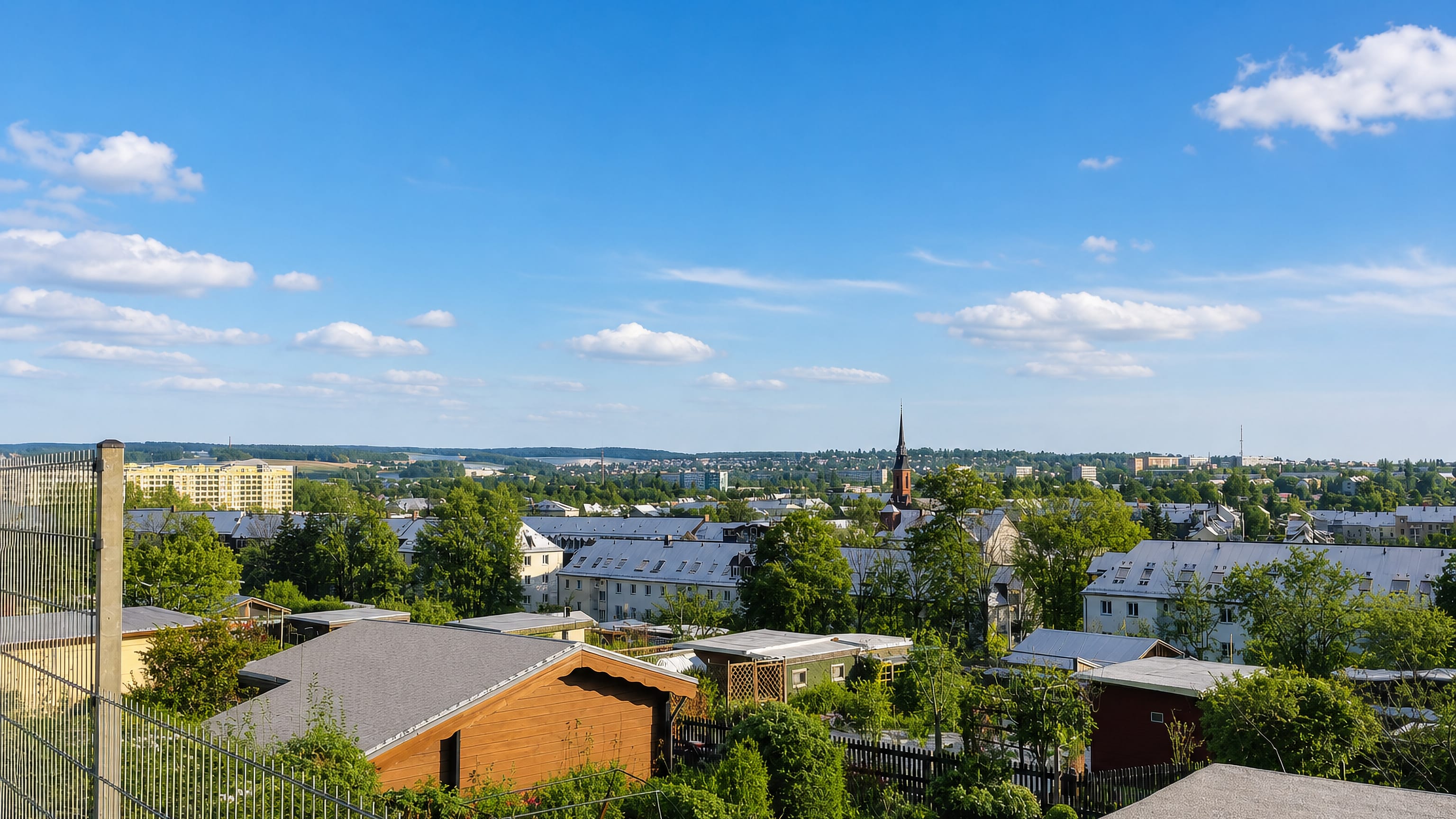 Rooftops, allotment gardens and a distant church spire seen from Gablenz on the eastern edge of Chemnitz.
