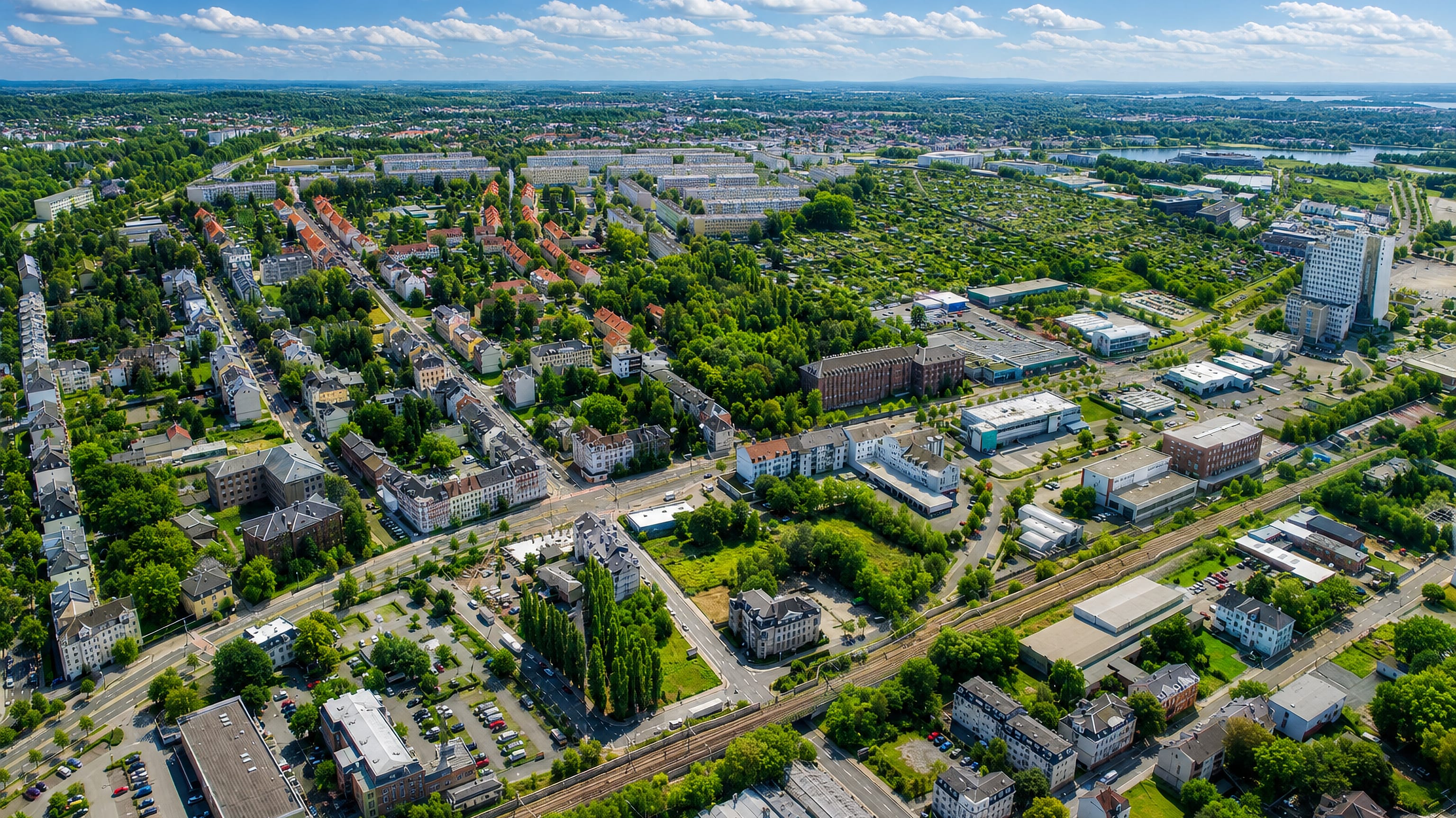Aerial view of Kappel, Chemnitz, with period apartment blocks, rail lines and commercial buildings.