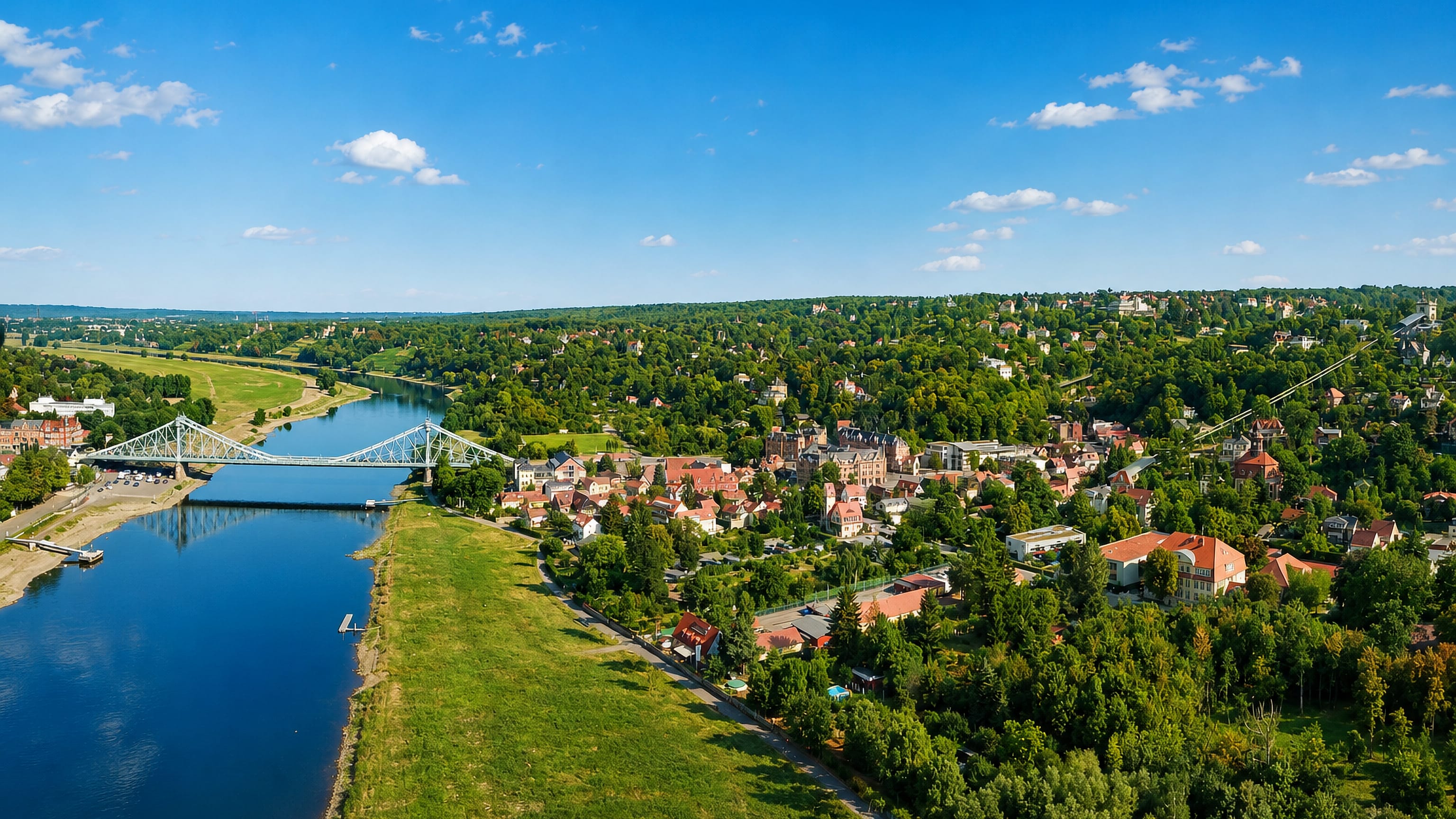 The blue Loschwitz Bridge over the Elbe at Loschwitz in Dresden, with villa-lined slopes above the river
