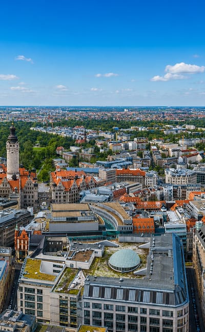 Aerial view over Leipzig's city centre with the New Town Hall tower rising above red-roofed streets