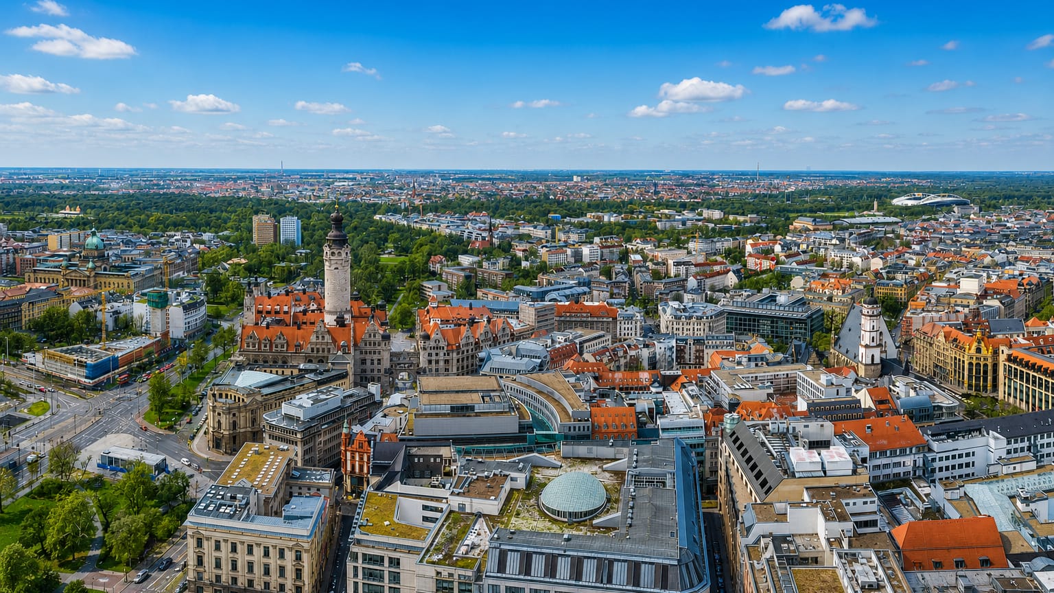 Aerial view over Leipzig's city centre with the New Town Hall tower rising above red-roofed streets