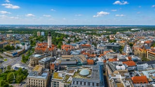 Aerial view over Leipzig's city centre with the New Town Hall tower rising above red-roofed streets