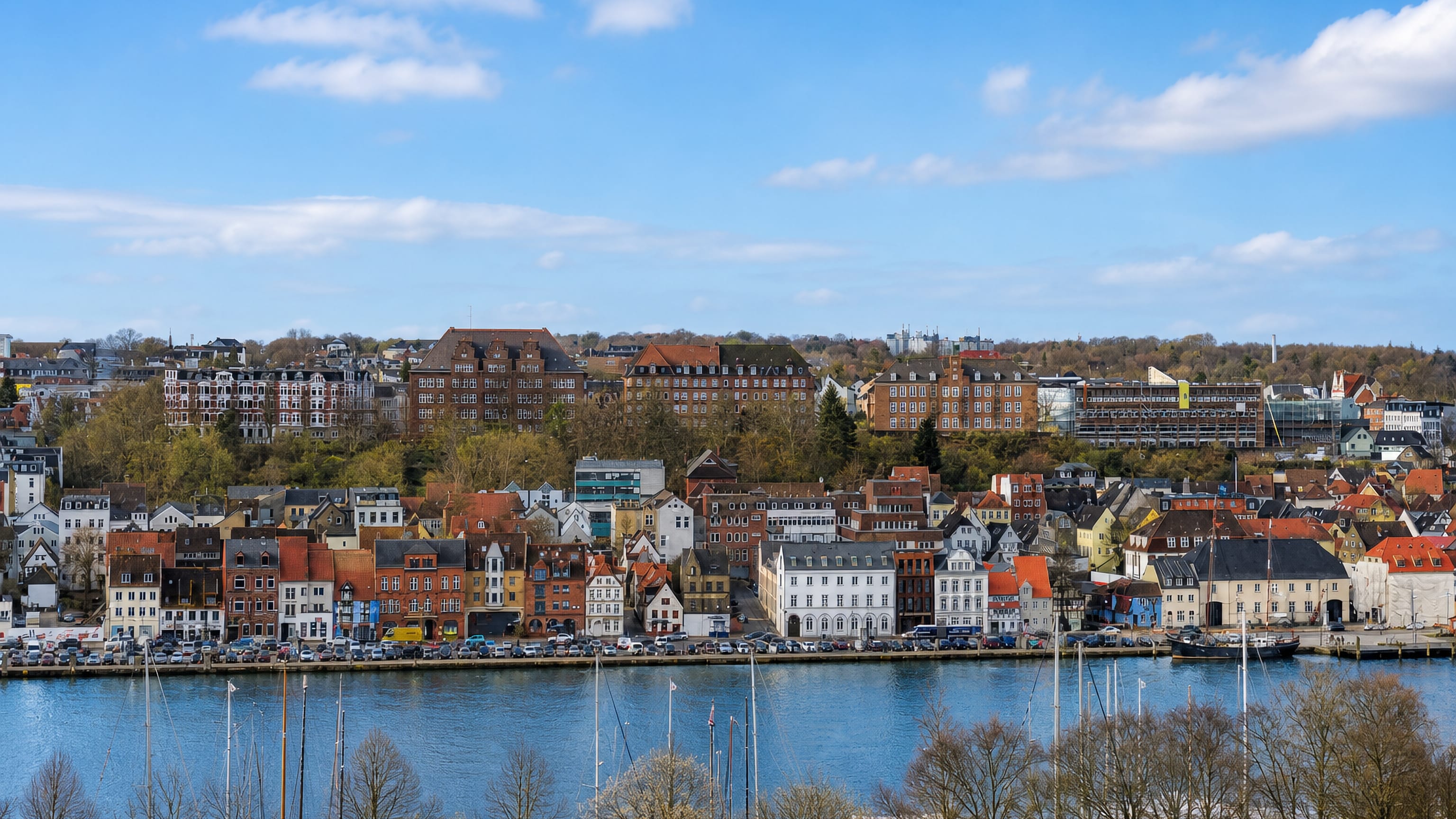 Flensburg's Duburg hillside of gabled townhouses rising above the harbour and sailing boats on the fjord.