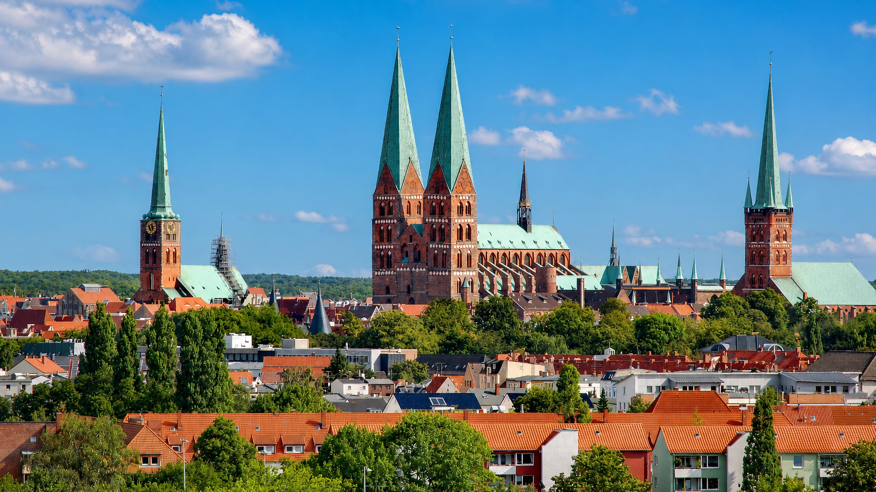 Lübeck's brick Gothic skyline with the twin green spires of St Marien and the towers of St Jakobi and St Petri