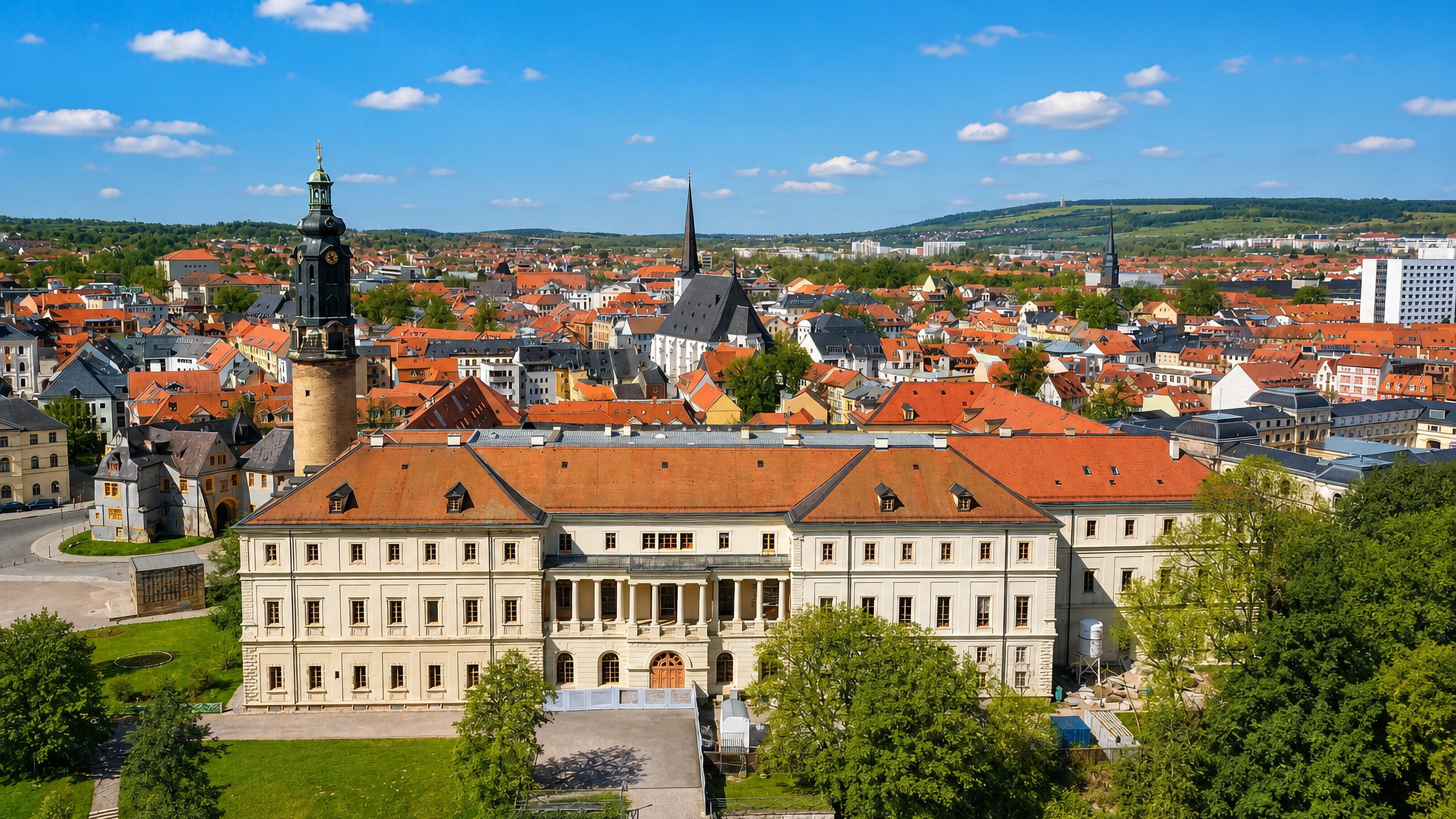 Weimar's baroque city palace and its green-domed tower above the red-roofed old town and the wooded Ilm valley