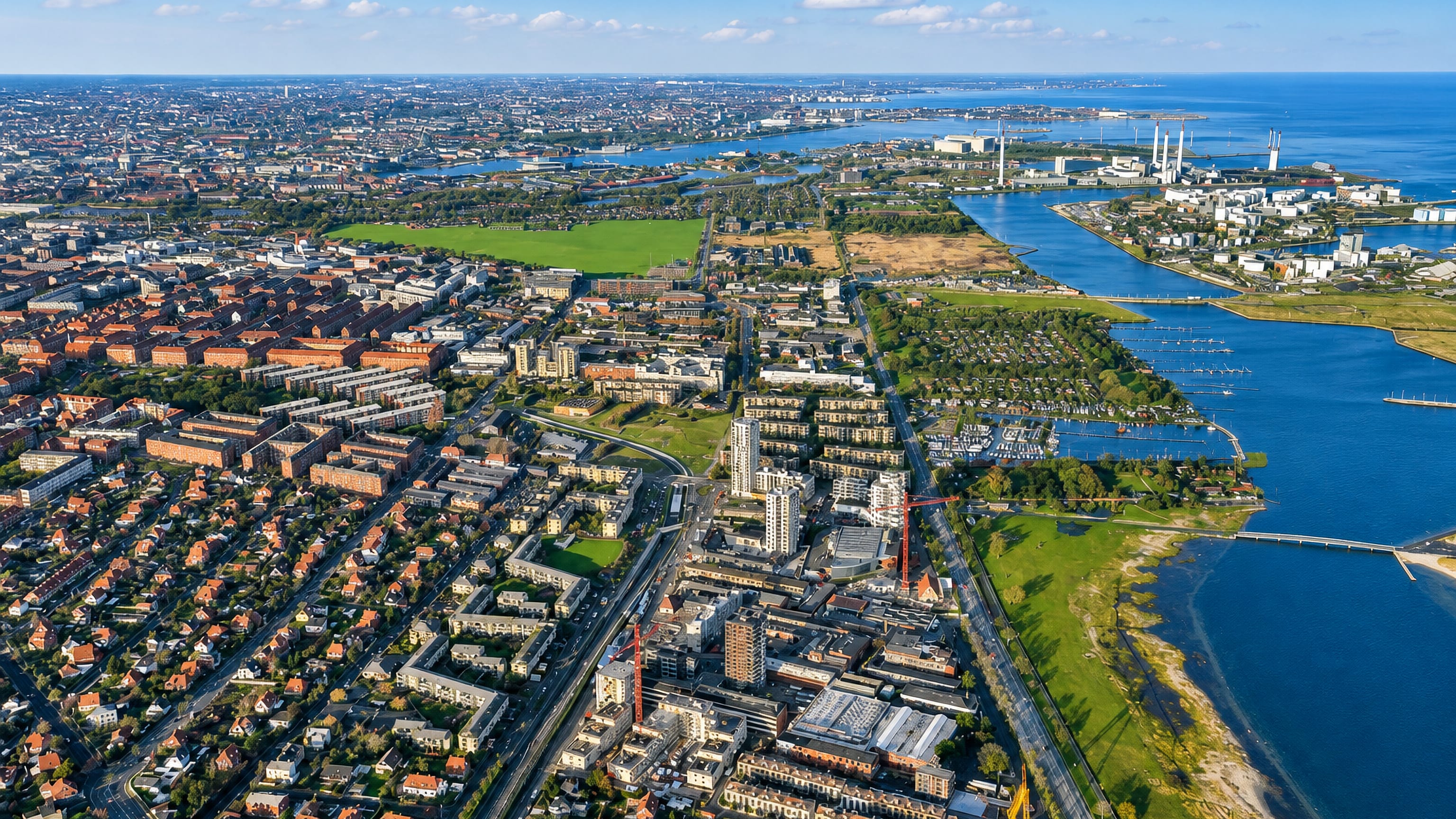 Amager Øst from the air, its blocks running between Copenhagen's harbour and the Amager Strandpark lagoon.