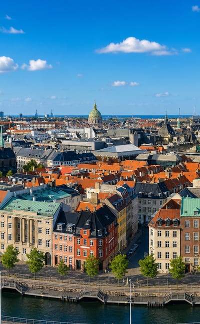 Aerial view of Copenhagen's old town, the green St. Nikolaj spire, red rooftops and colourful canal-side houses