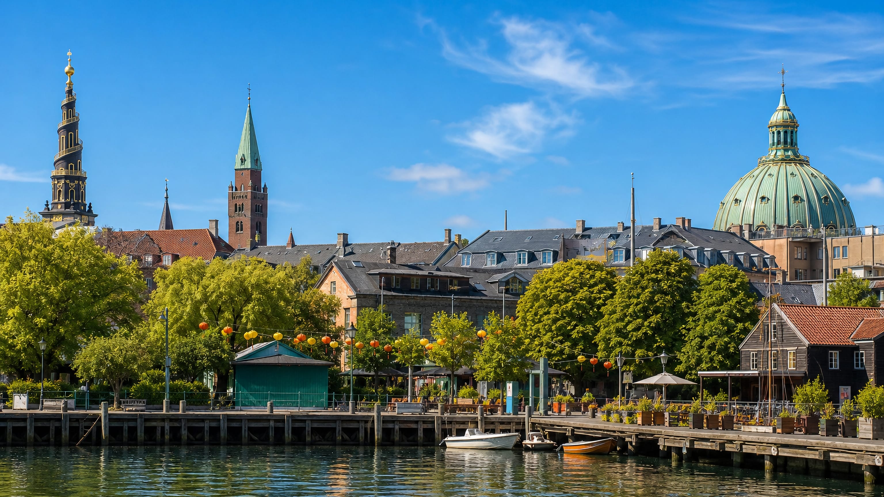Christianshavn waterfront by Christiania in Copenhagen, with the spiral spire of Our Saviour and a green dome