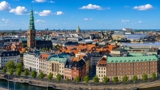 Aerial view of Copenhagen's old town, the green St. Nikolaj spire, red rooftops and colourful canal-side houses