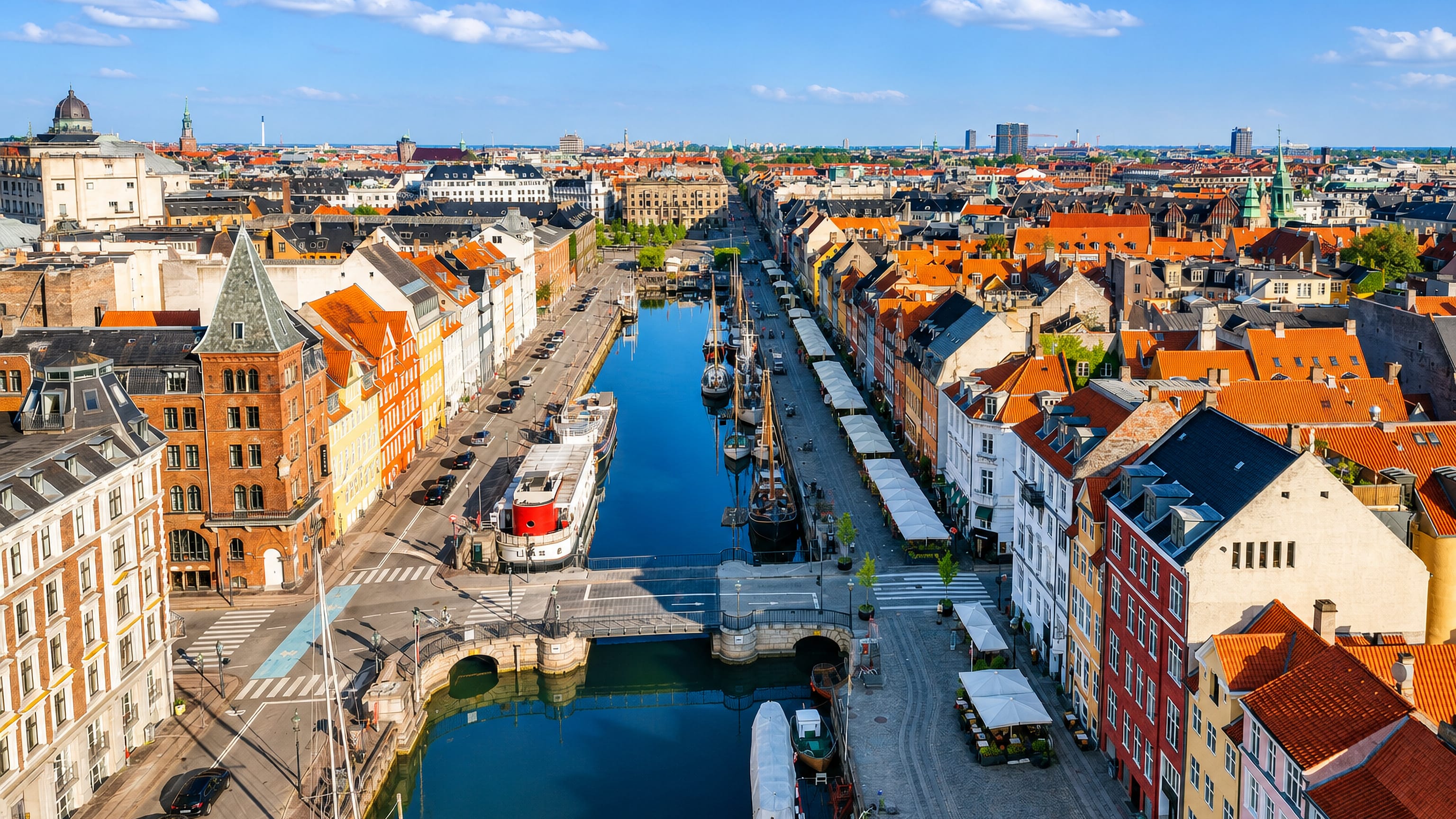 Aerial view of Nyhavn's colourful gabled townhouses, wooden ships and quayside cafes in Copenhagen.