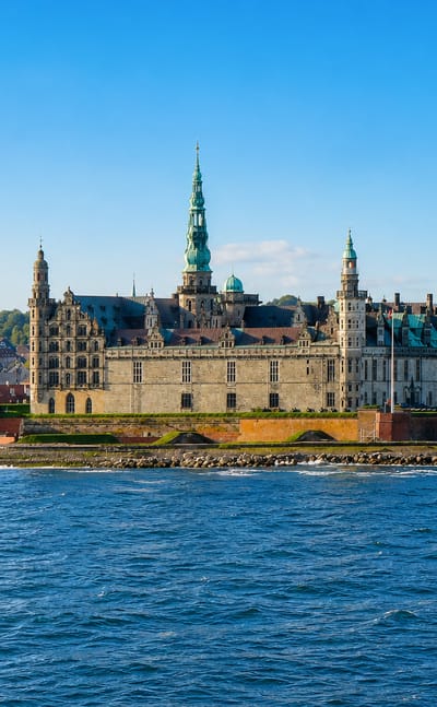 Kronborg Castle with its green copper spires seen across the Oresund water in Helsingor, Denmark.