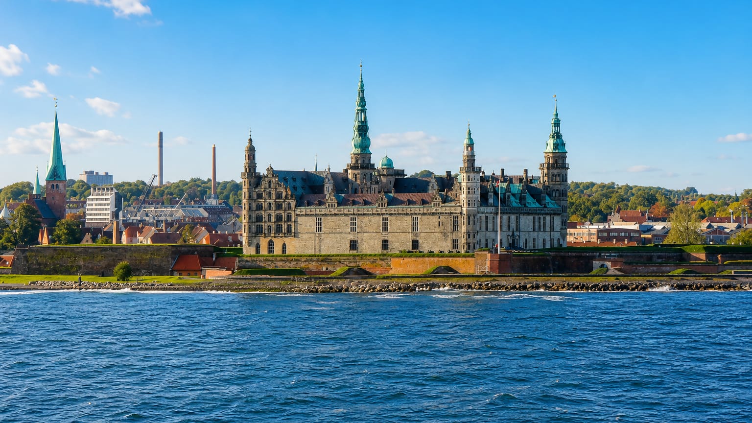 Kronborg Castle with its green copper spires seen across the Oresund water in Helsingor, Denmark.